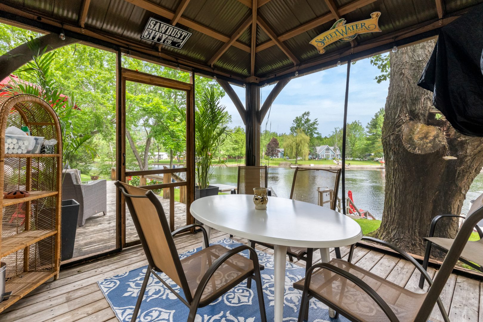 A round table with beige chairs in a screened-in porch