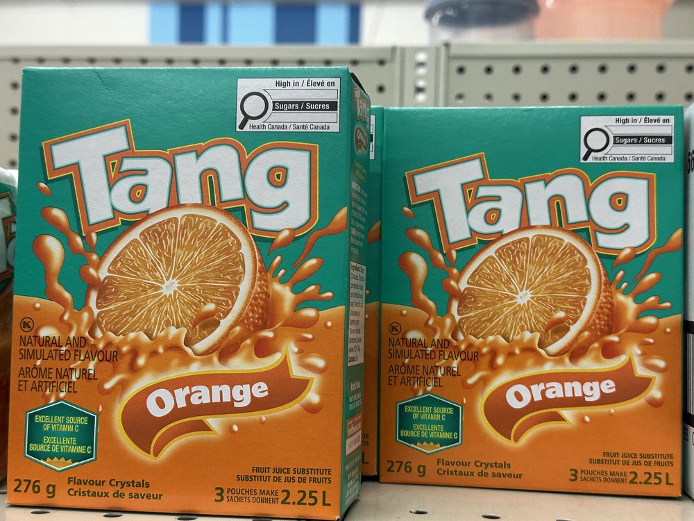 Two packages of Tang on a shelf