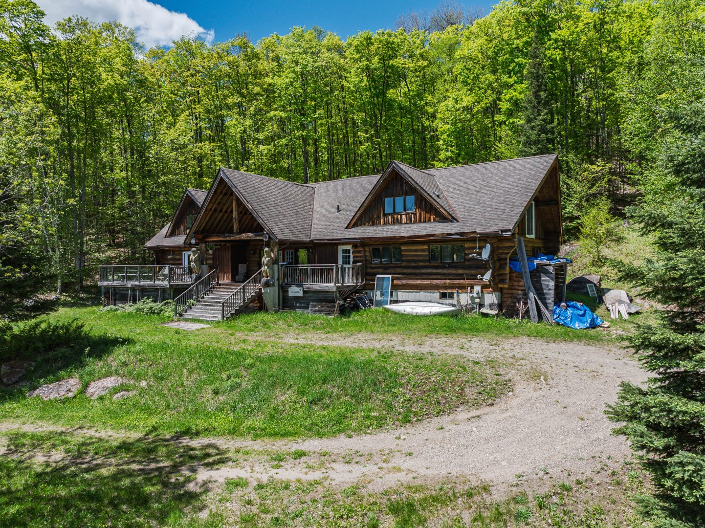 A log cabin tucked away on a forested property