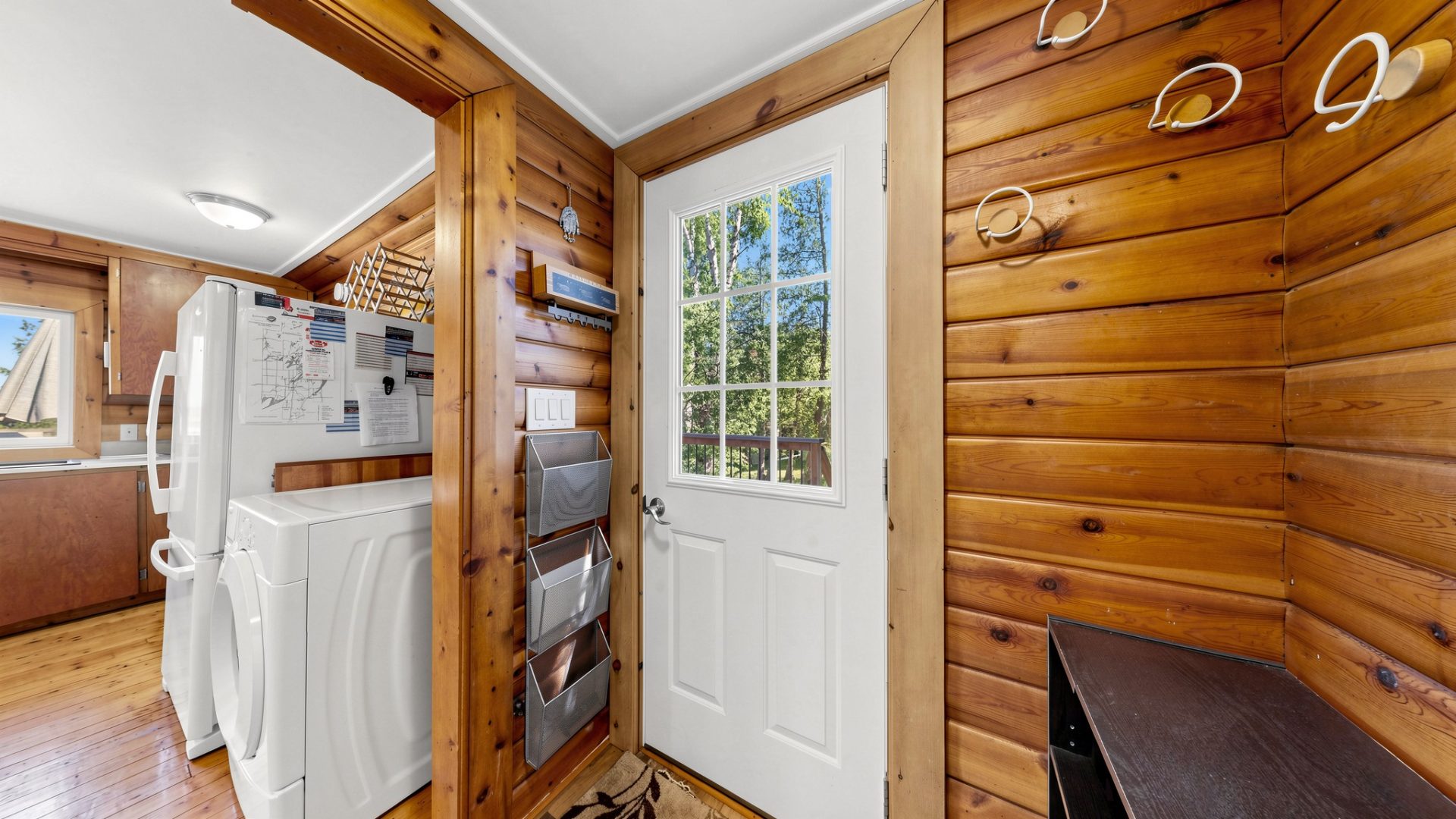 A white front door in a wood cabin