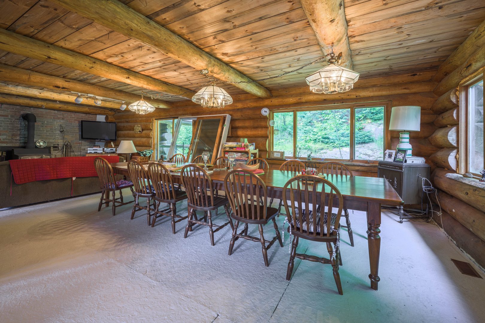 A long wood dining table with wood chairs