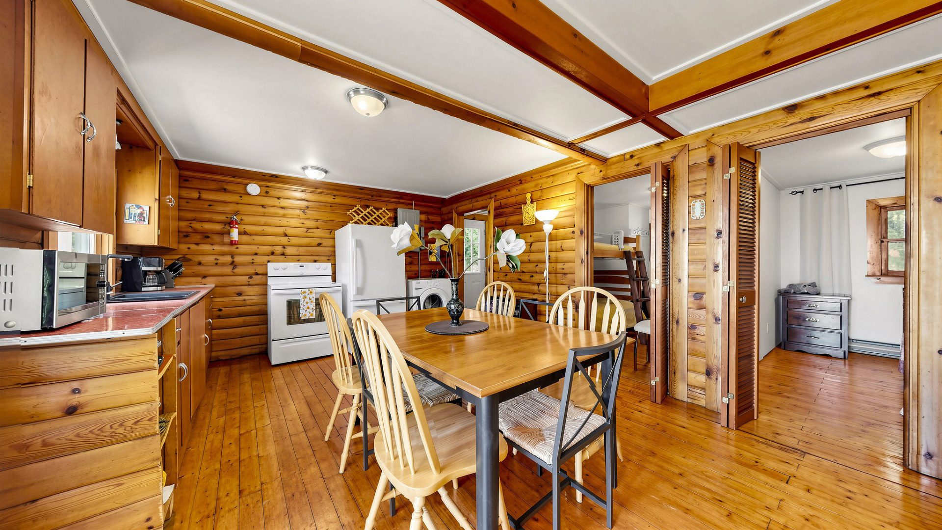 A wood dining table in an open-concept kitchen and dining area