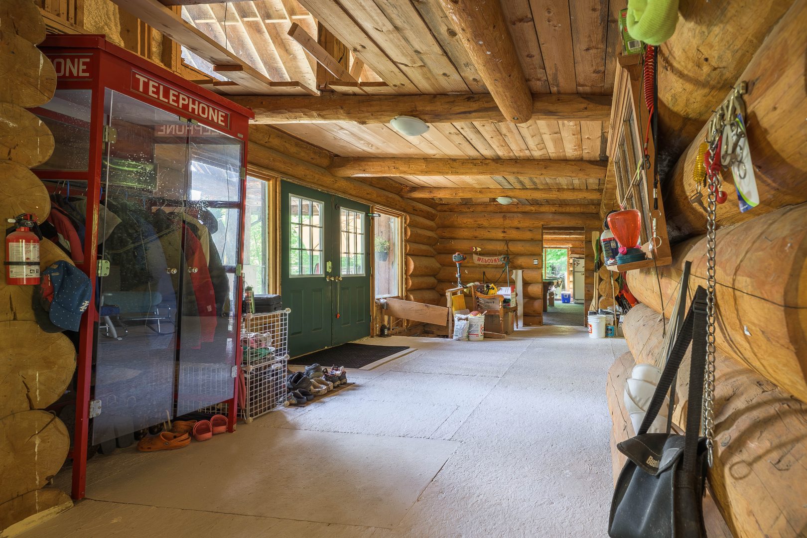 A spacious entryway with wood beams on the ceiling