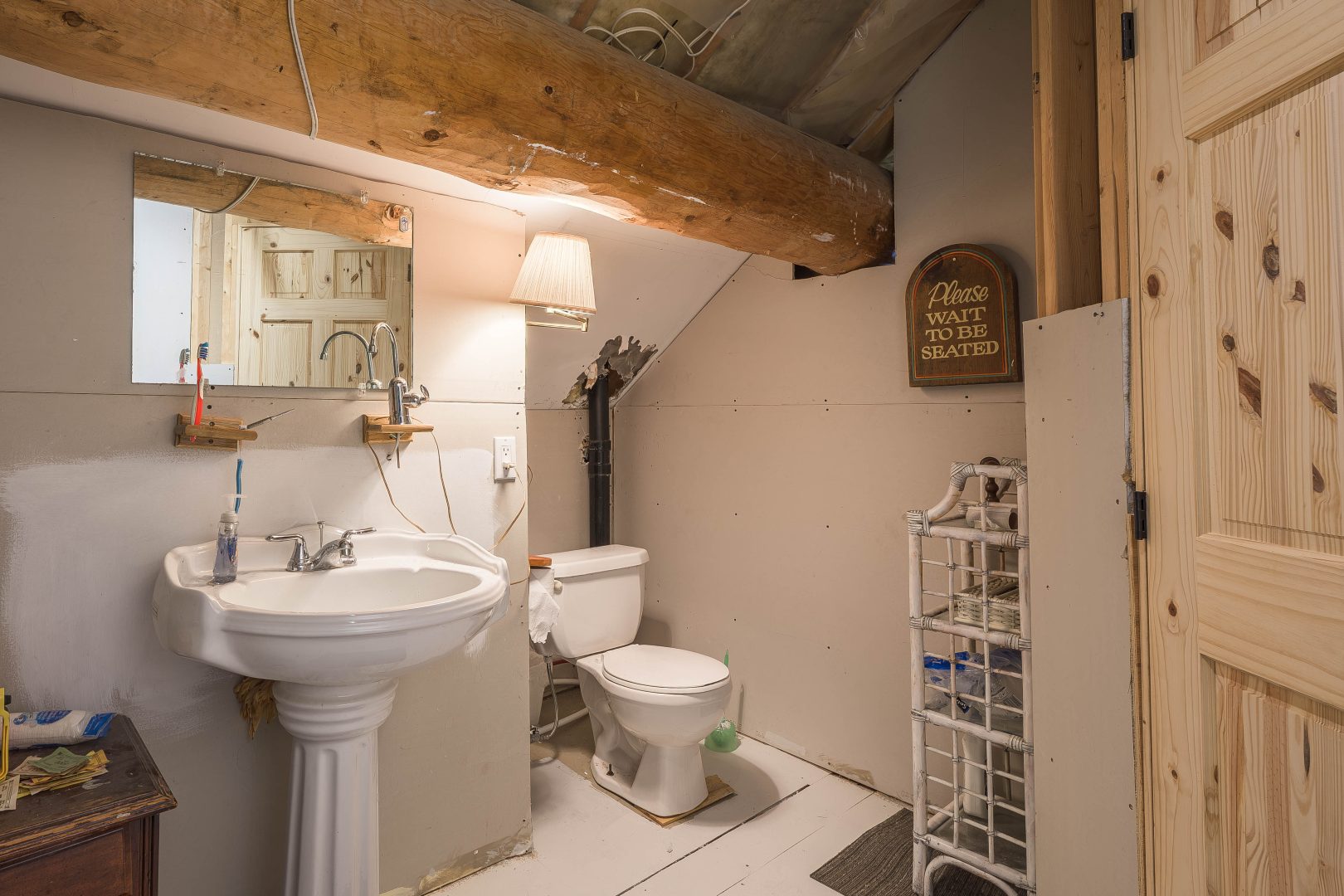 A beige bathroom with a white vanity