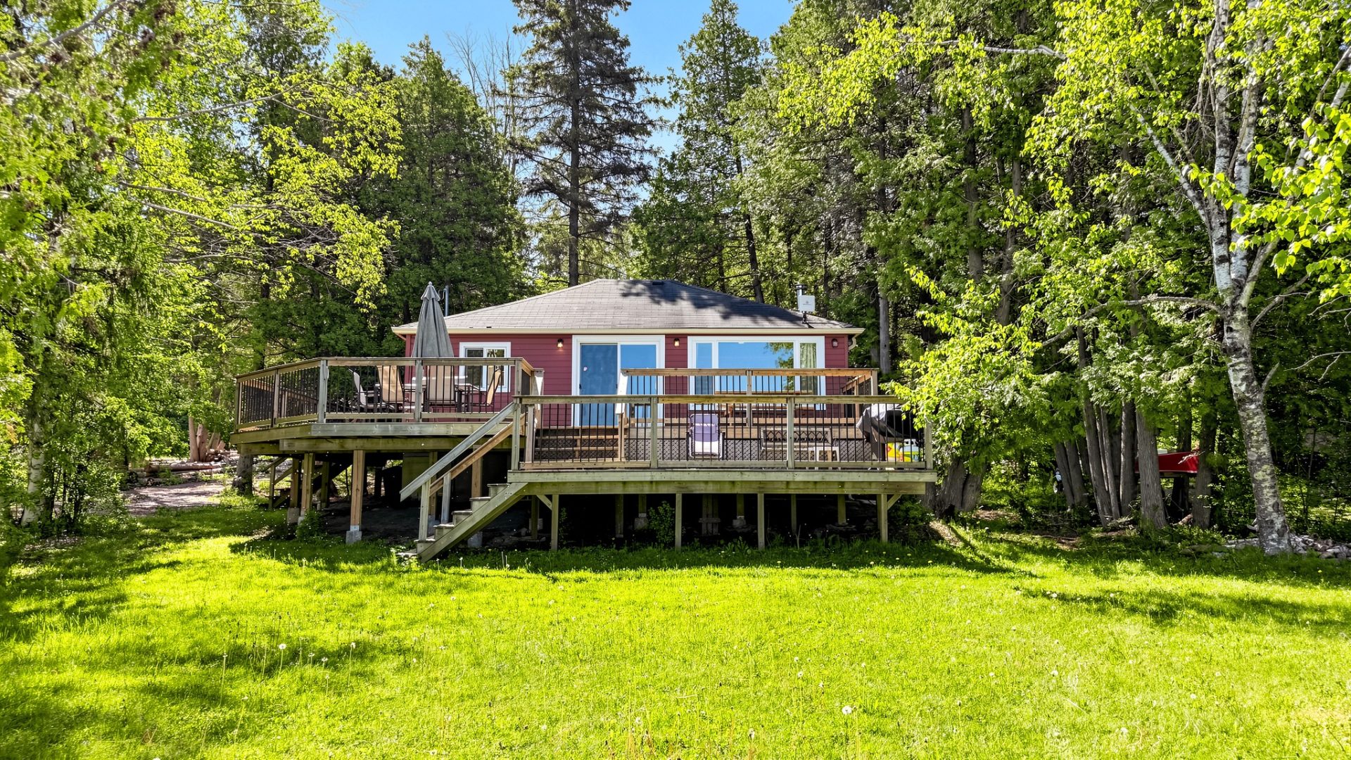 A red bungalow cottage with a double deck