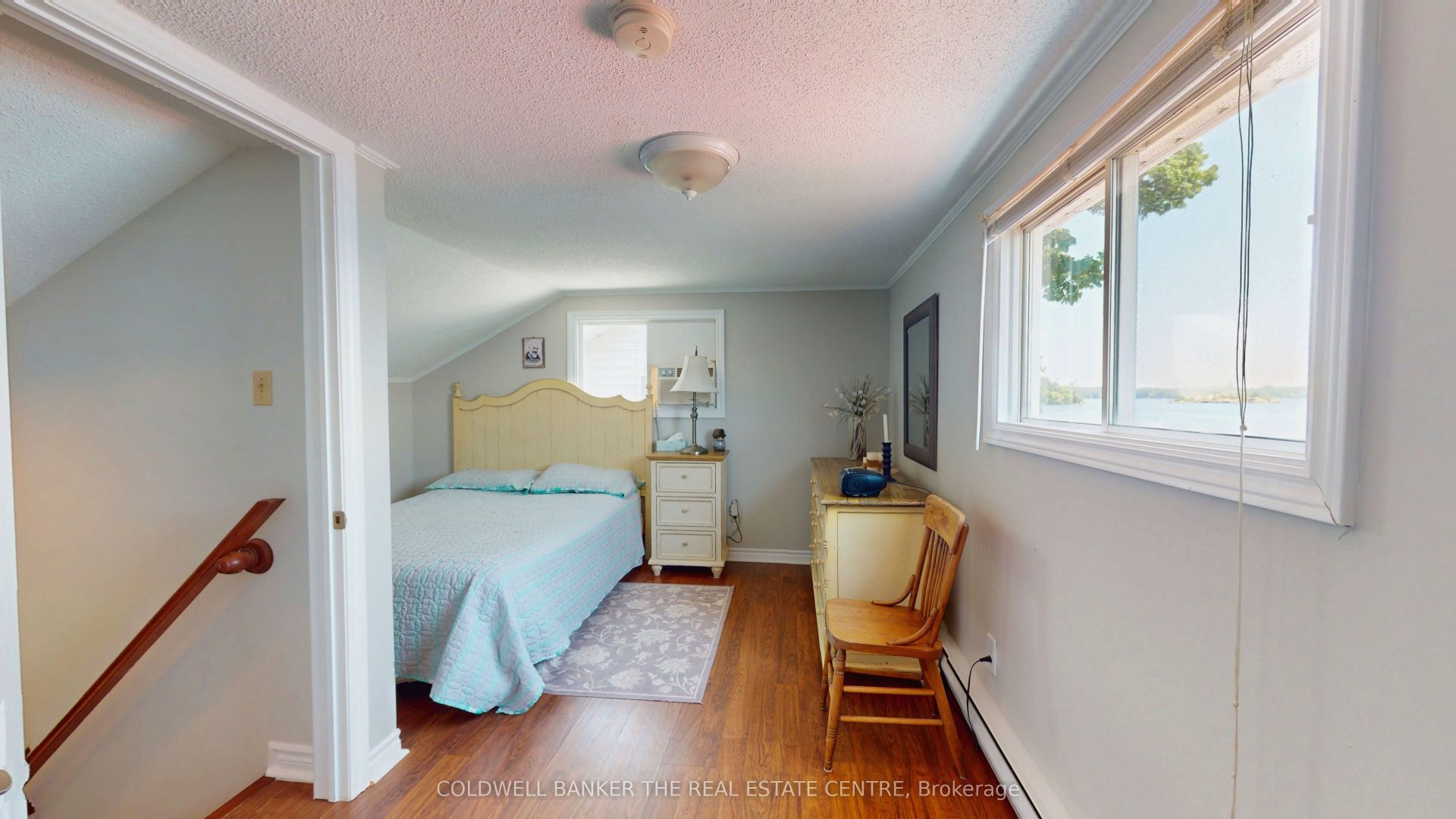 A blue bed in a light grey bedroom