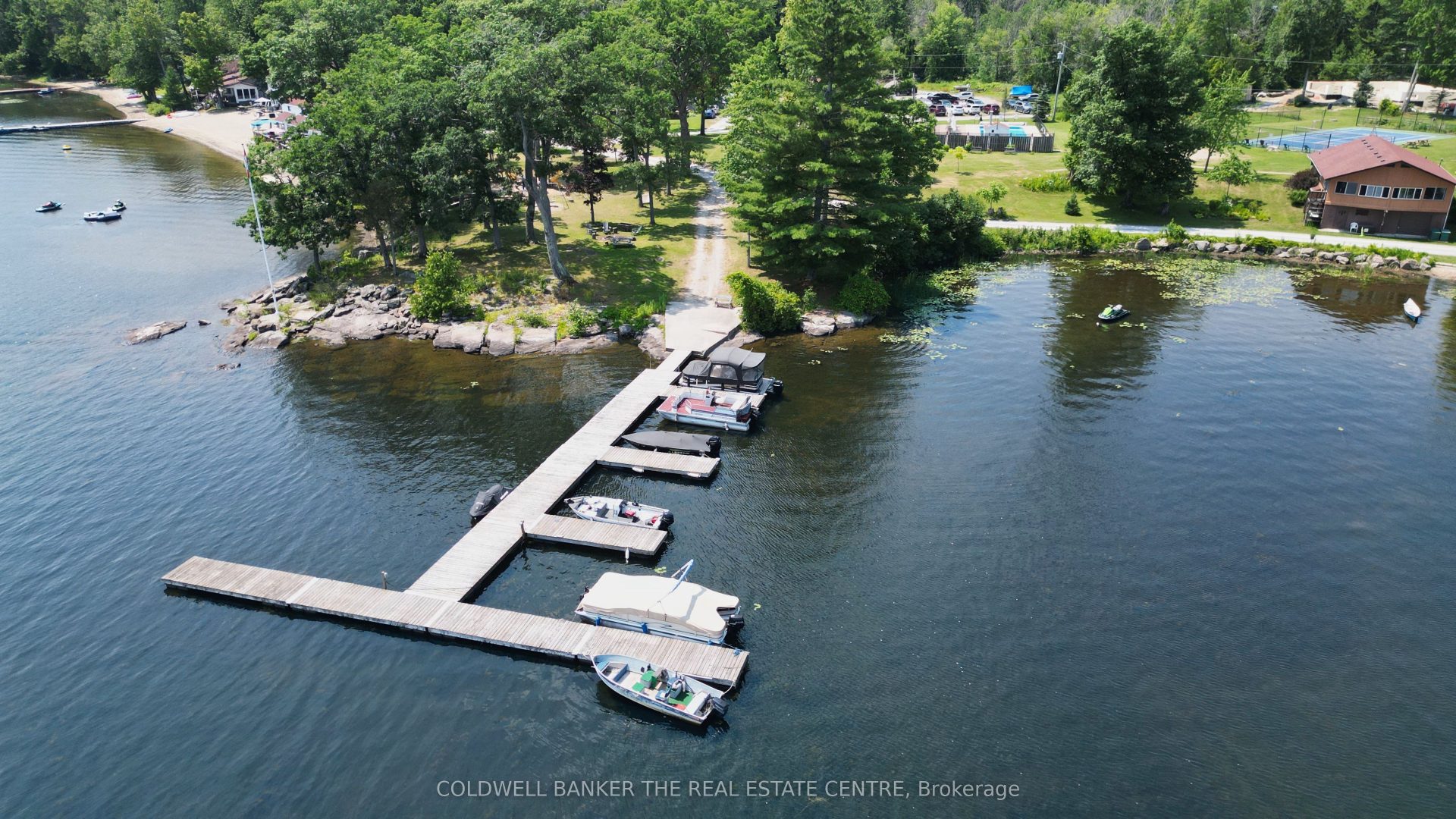 Aerial view of a long dock with boats parked on the right side