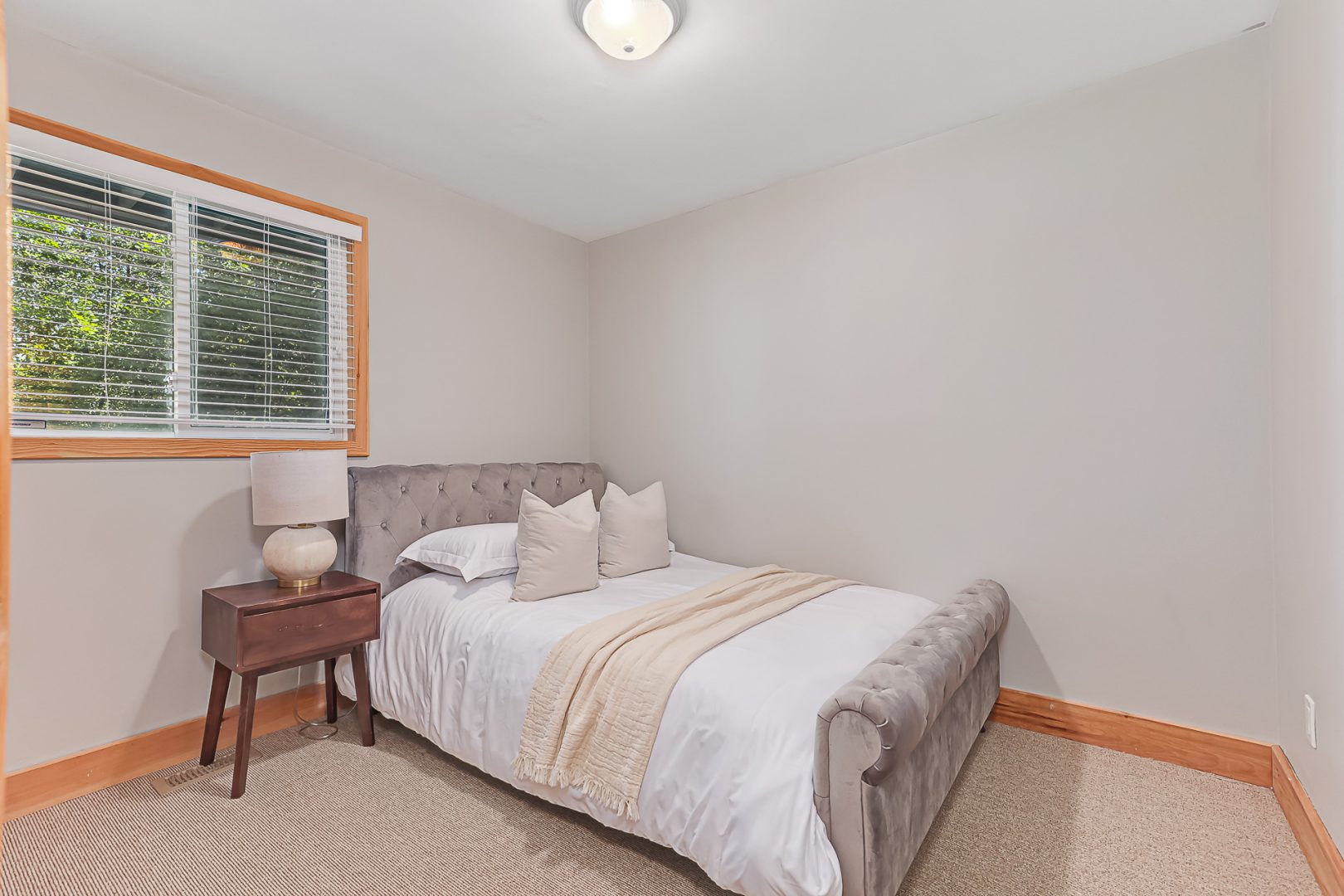 A white bed in a white bedroom