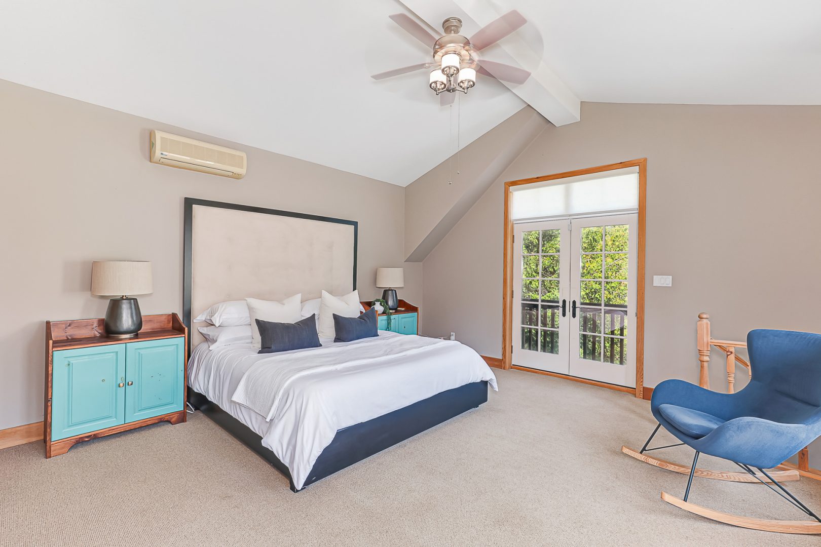 A white bed in a beige bedroom