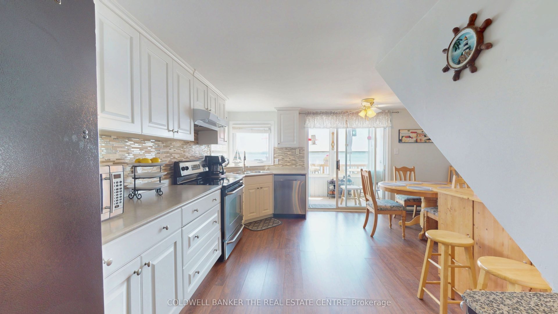 A white kitchen with a beige backsplash