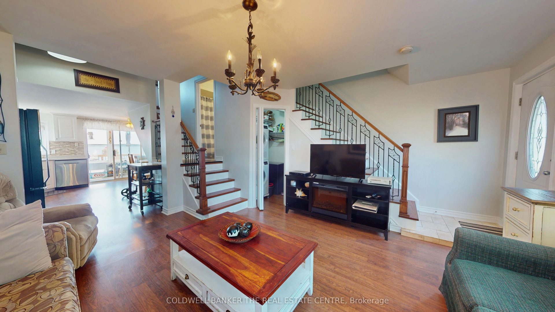 A wood coffee table in a spacious living room next to a TV stand