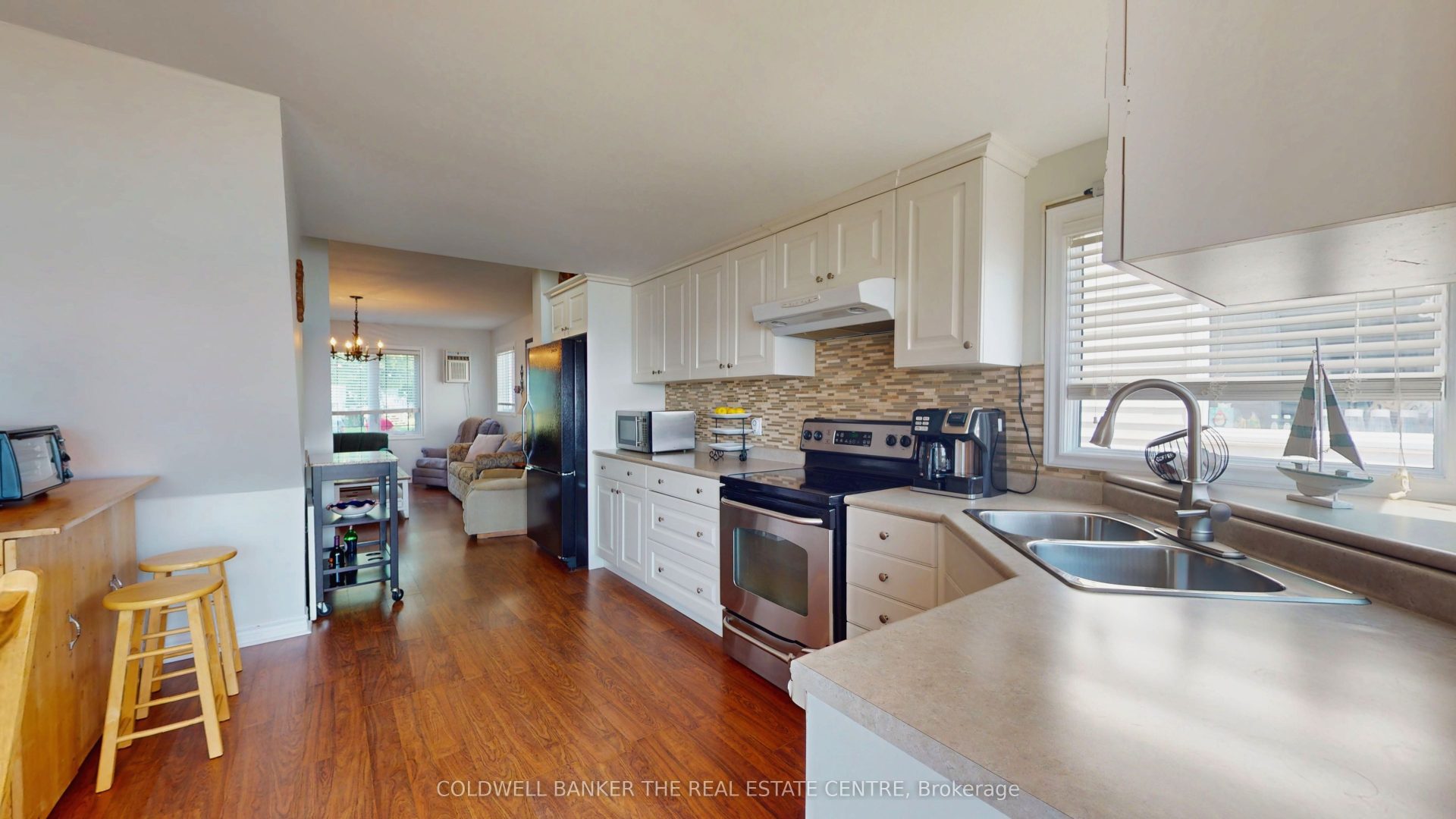 A white open-concept kitchen with a beige backsplash