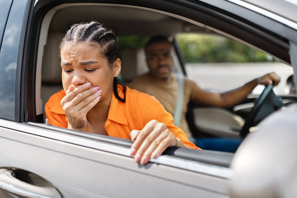 A young woman feeling car sick