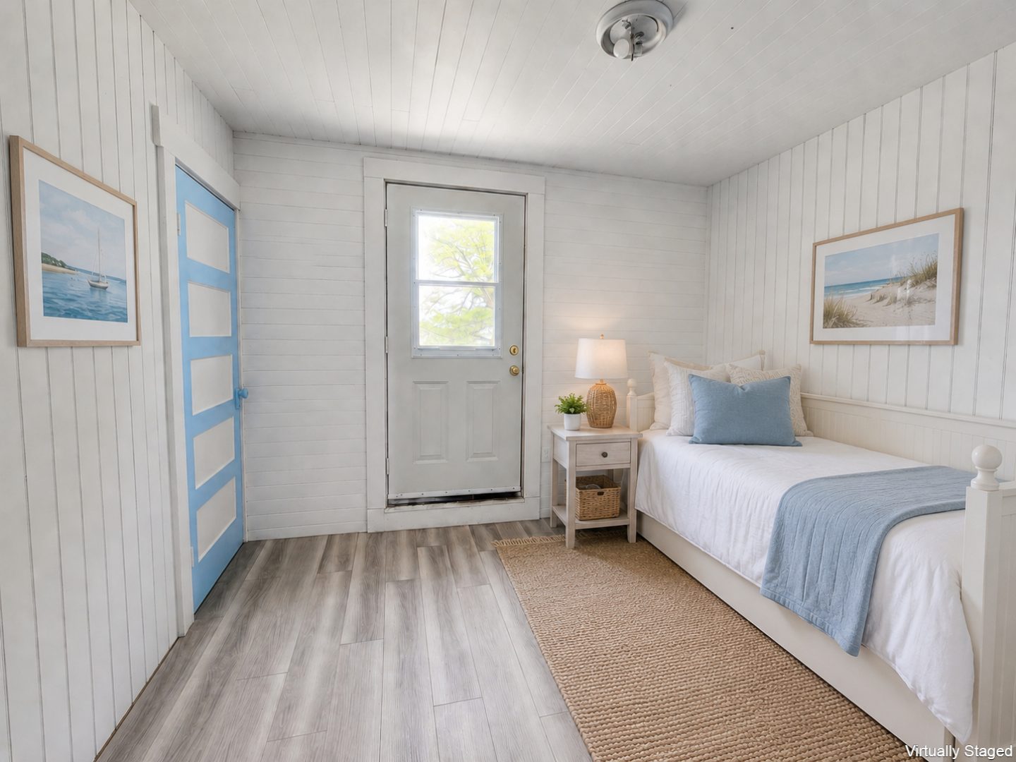A white daybed in a white and blue bedroom