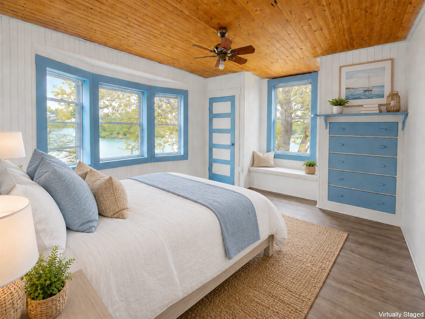 A white bedroom with light blue trim along the window frames