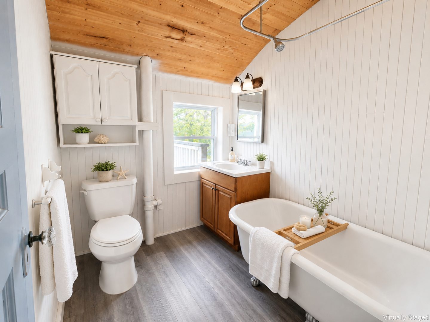 A white bathroom wit ha white clawfoot tub