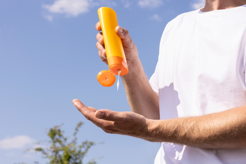 A man applying sunscreen