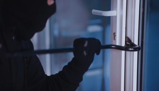 A vandal breaking in with a crowbar