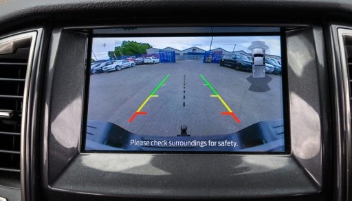 Modern cars infotainment screen displaying a live feed from the backup reverse camera, assisting the driver with safe parking and obstacle detection