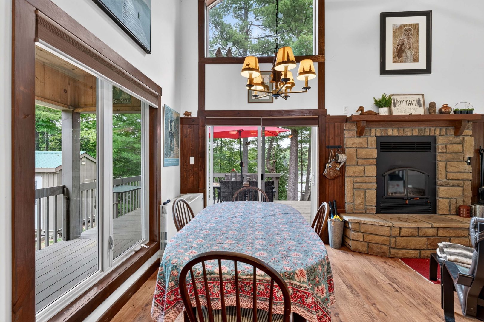 A rounded dining table with wood chairs in a spacious living room