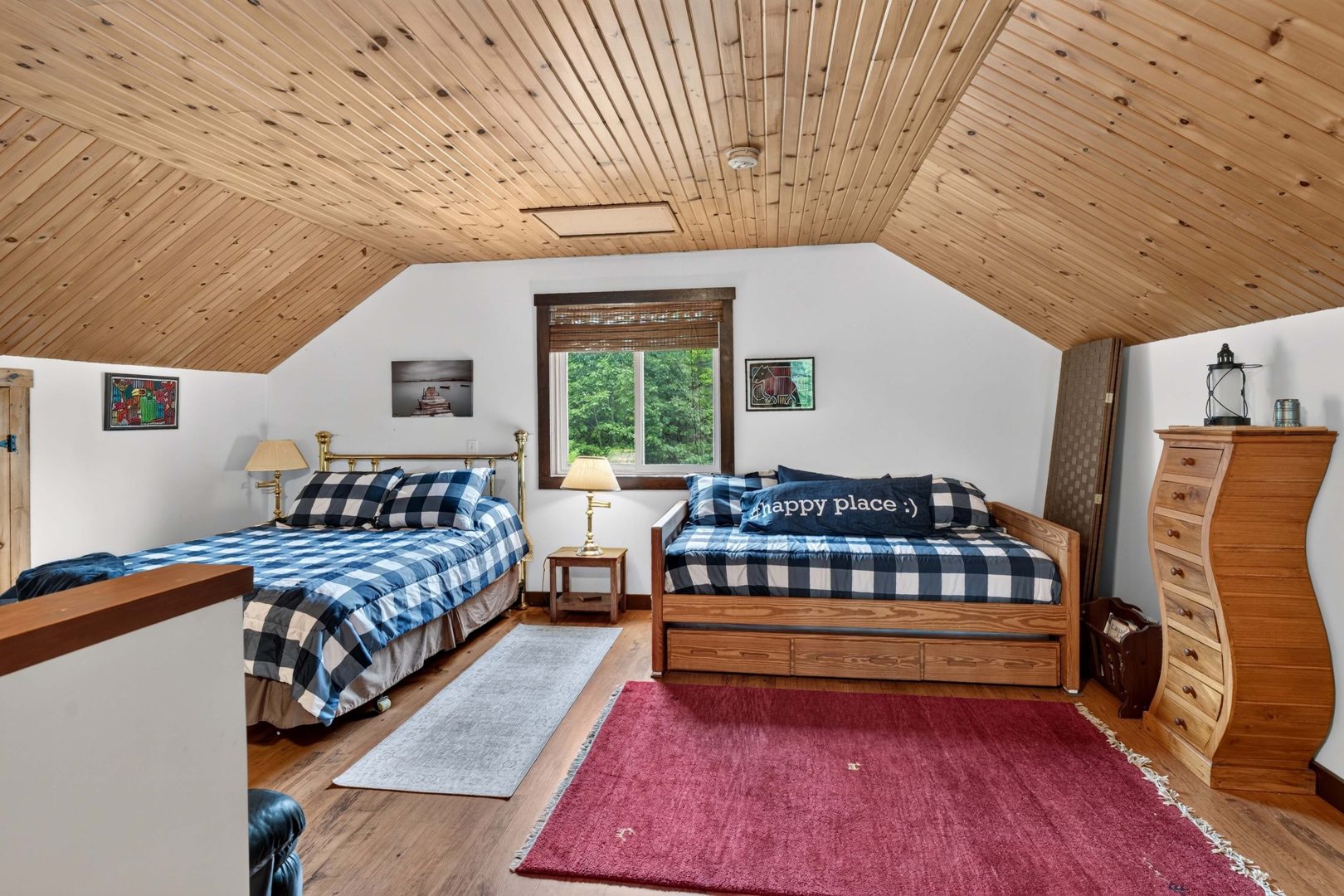 Two blue-and-white checked beds in a loft bedroom