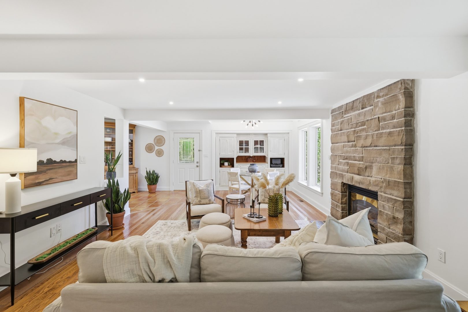 A beige couch faces a wood coffee table in a living room