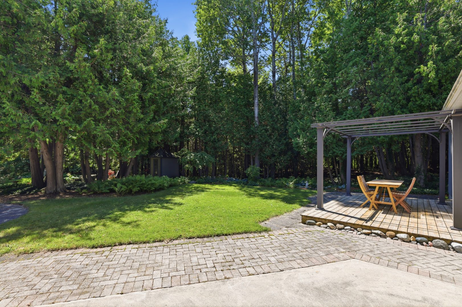 A spacious backyard with a pergola
