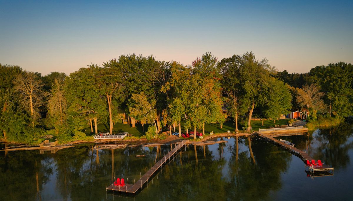 A forested shoreline property on a lake with an extended dock