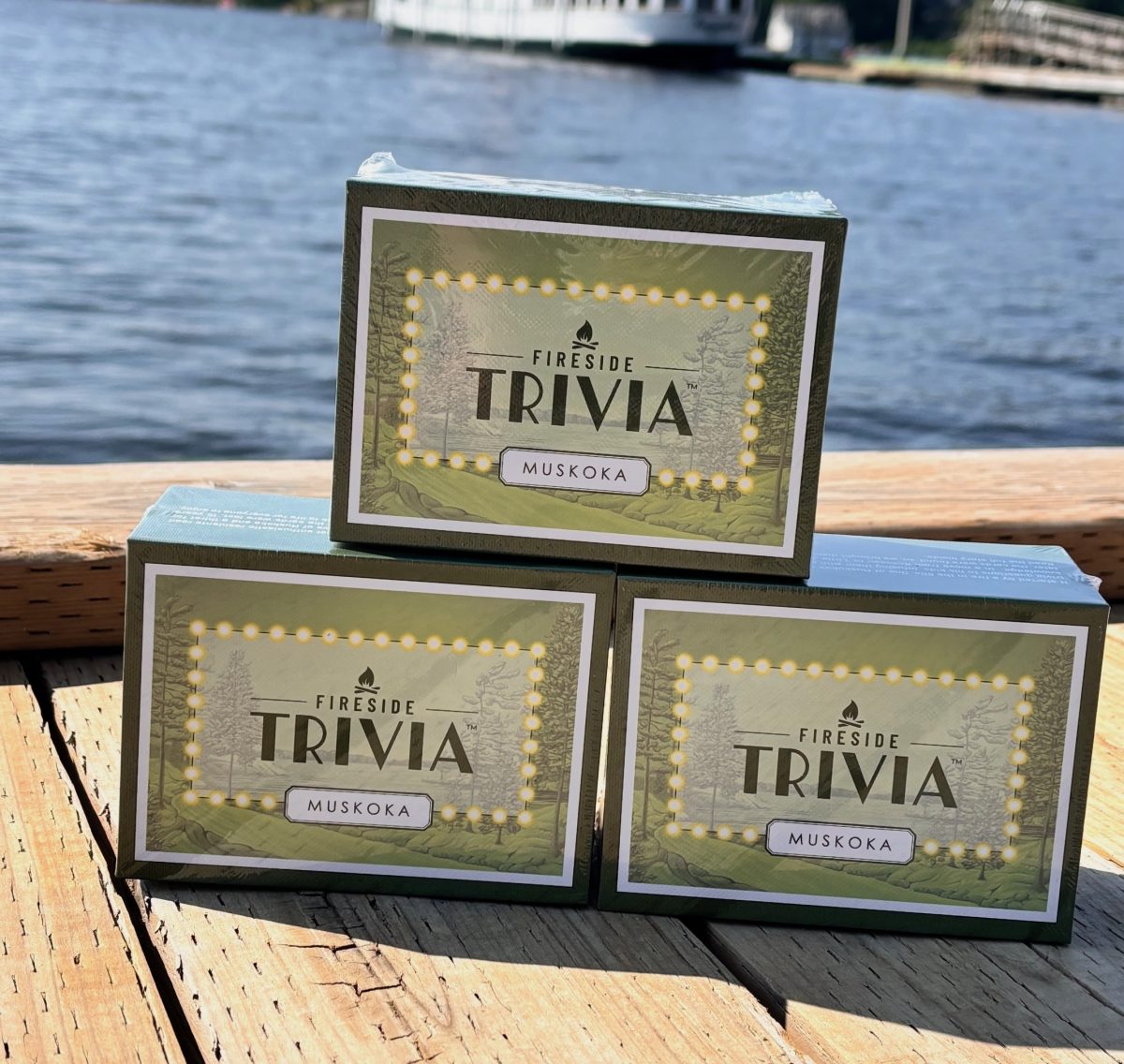 Three boxes of the trivia game stacked on the dock