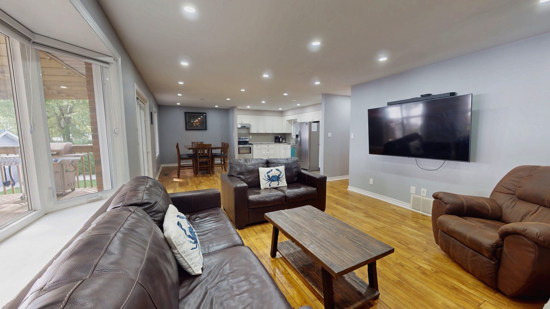 A living area with grey couches in a light blue room