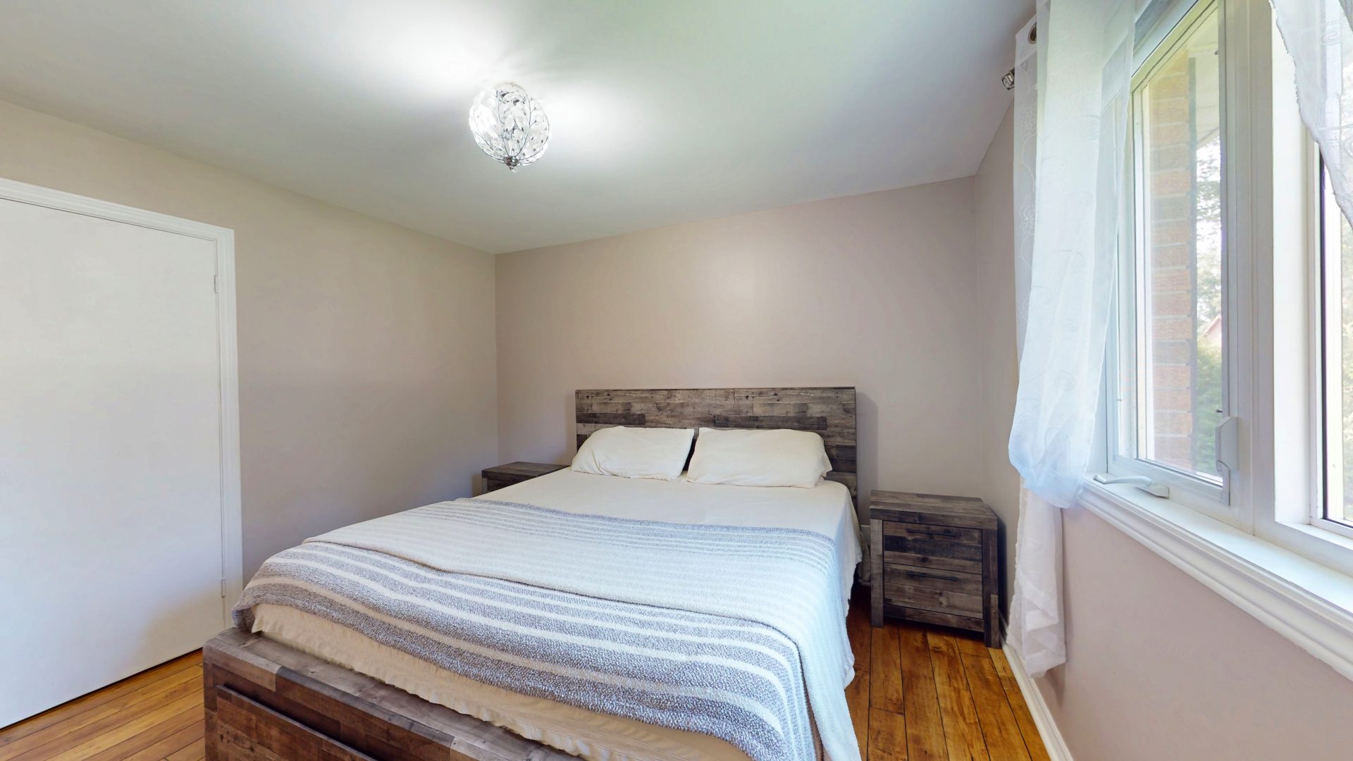 A light blue bed in a beige bedroom