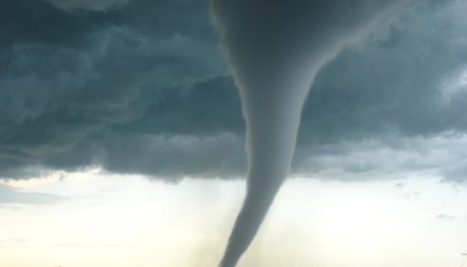 An image of a large tornado over a field