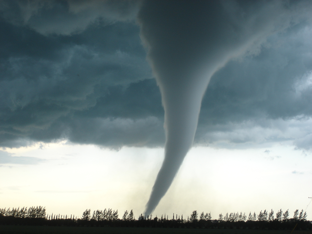 An image of a large tornado over a field